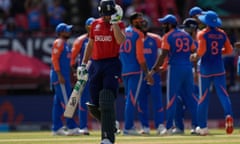 England's captain, Jos Buttler, walks off the field after losing his wicket.