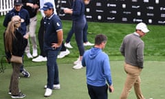 Rory McIlroy (right) walks past Patrick Reed (second left) at the Dubai Desert Classic