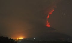 A red glow in the crater of Mount Agung on Bali is seen in the column of ash and smoke rising from the volcano.