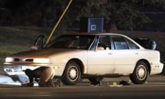 Investigators search a car at the scene of a police involved shooting in Falcon Heights, Minnesota on 6 July 2016.