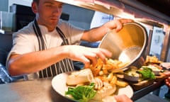 Chef putting chips on to plate for serving