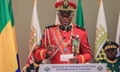 Gen Brice Oligui Nguema, dressed in the red ceremonial uniform of Gabon's Republican Guard, speaks at a lectern