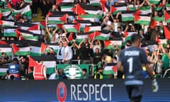 Celtic fans hold up Palestinian flags