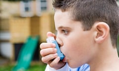 A boy using an asthma inhaler.