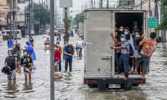 People navigate flooded streets after heavy monsoon rain in Rizal, the Philippines.