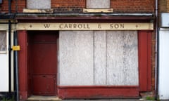 A closed down and boarded up shop on Crewe High Street. 