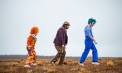 Three disparate clowns walking across a field in Apocalypse Clown
