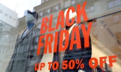 Black Friday up to 50% off sign in red on a shop window