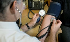 A doctor testing a patient's blood pressure
