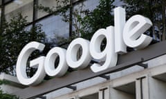 The Google sign is shown over an entrance to the company's building in New York. Google has agreed to pay $700m according to the terms of an antitrust settlement.