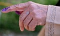 A person's finger inked from voting.