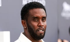 Middle-aged Black man with full beard, diamond in ear, white suit.