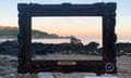 A view of Guernsey’s coastline can be seen through an empty picture frame on a beach, part of the Renoir Walk.