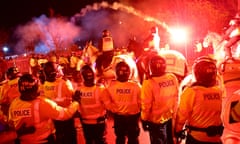 Legia Warsaw fans let off flares as they clash with police officers outside Villa Park.