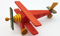 Hand made wooden toy airplane on a white background.