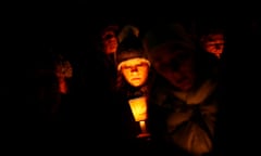 People take part in a candlelight vigil in Newtown, Connecticut, one week after the 2012 shooting at Sandy Hook elementary school claimed the lives of 26 people.