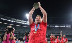 Sam Curran holds the T20 World Cup trophy aloft following England’s victory against Pakistan