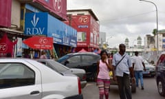 People walk towards the Treichville market in the Ivorian capital Abidjan on May 3, 2016. / AFP PHOTO / ISSOUF SANOGOISSOUF SANOGO/AFP/Getty Images