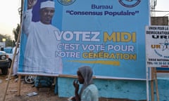 A pedestrian walks past a campaign poster of  Mahamat Idriss Déby Itno  in N'Djamena