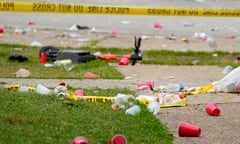 Litter and police tape on a grass lawn.