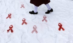 World Aids Day<br>A school girl walks past red ribbons stencilled in the snow in Dublin city centre by  Artivist' Will St Leger to mark world Aids Day. PRESS ASSOCIATION Photo. Picture date: Wednesday December 1, 2010. To mark World Aids Day, Open Heart House a charity that supports people living with HIV and AIDS are organising a 24 hour Sleep Out in Dublin city centre. Photo credit should read: Niall Carson/PA Wire