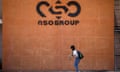 A woman walks past the entrance of an NSO Group building