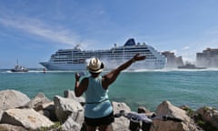 A woman from Cuba waves Adonia leaves port in Miami, Sunday, May 1, 2016, en route to Cuba. After a half-century of waiting, passengers finally set sail on Sunday from Miami on an historic cruise to Cuba. Carnival’s Cuba cruises, operating under its Fathom band, will visit the ports of Havana, Cienfuegos and Santiago de Cuba. (Patrick Farrell/The Miami Herald via AP) MAGS OUT; MANDATORY CREDIT