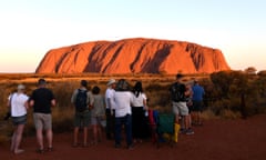 Tourists looking at Uluru