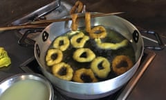 picarones being fried on a Lima street.