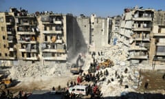 Syrian soldiers use heavy machinery to sift through the rubble of a collapsed building in Aleppo.