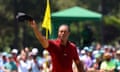 Tiger Woods acknowledges the crowd on the green on the 18th hole after completing his final round