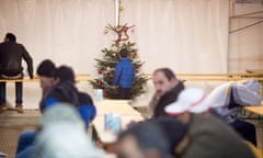 A young refugee boy stands by a Christmas tree in a tent in front of the State Office for Health and Social Affairs (LaGeSO) in Berlin, Germany, 02 December 2015.