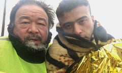 ai weiwei with a young man wrapped in blankets in human flow