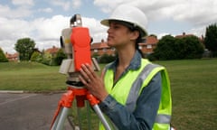 Female student surveying wearing high visibility vest and hard hat