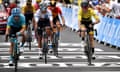 Adam Yates crosses the finish line for stage eight in Loudenvielle with Egan Bernal and others