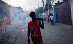 A man holds a machete while walking