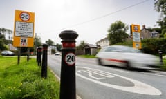 A car drives past a 20mph sign