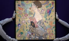 Employee position an artwork entitled 'Dame mit Facher (Lady with a Fan)' by Austrian artist Gustav Klimt