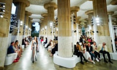 Spectators watch a model in the fashion show