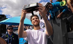 Cameron Norrie takes selfies with fans after victory against Italy's Giulio Zeppieri in the Australian Open.