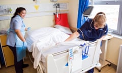 NHS staff change a hospital bed between patients at St. Mary's Hospital, Southampton.