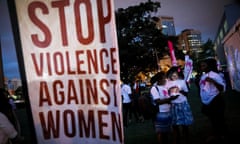 Kenyan women hold a vigil for femicide victims. A sign reads: 'Stop violence against women'