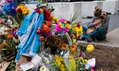 FILE - Amy Biden, of New York, hugs her dog Smokey after placing flowers she brought to a makeshift memorial that honors victims of an attack who were struck and killed by a rental truck driven by indicted suspect Sayfullo Saipov in New York, Nov. 4, 2017. A jury said Monday, March 13, 2023 it could not reach a unanimous decision on whether to impose the death sentence on an Islamic extremist who killed eight people using a speeding truck on a popular New York bike path. A unanimous verdict is required for a death sentence. (AP Photo/Craig Ruttle, File)