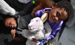 A child smiles during a distribution of meals aboard the rescue ship "Aquarius", on May 25, 2016 a day after a rescue operation of migrants and refugees off the Libyan coast. The Aquarius is a former North Atlantic fisheries protection ship now used by humanitarians SOS Mediterranee and Medecins Sans Frontieres (Doctors without Borders) which patrols to rescue migrants and refugees trying to reach Europe crossing the Mediterranean sea aboard rubber boats or old fishing boat.  / AFP PHOTO / GABRIEL BOUYSGABRIEL BOUYS/AFP/Getty Images