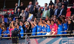 Harrison Burrows and the Peterborough manager, Darren Ferguson, lift the EFL trophy at Wembley