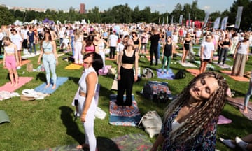 People doing yoga in a park