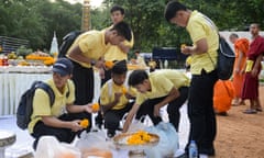 Members of the ‘Wild Boars’ football team prepare flowers to mark the first anniversary of their rescue from the Tham Luang cave, and pay their respects to the diver who died during the rescue efforts.