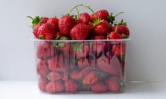 Fresh strawberries in plastic container isolated on white