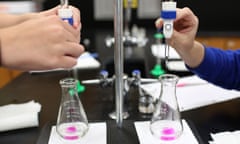 In this July 21, 2015 photo, students use a base to neutralize an acid during a summer school chemistry class at Neuqua Valley High School, in Naperville, Ill. A new online science exam that will be introduced to some students this coming school year signals a change in the way the subject is taught in Illinois. The exams are based on Next Generation Science Standards, which cover controversial topics like evolution and climate change. (Abel Uribe/Chicago Tribune via AP) MANDATORY CREDIT CHICAGO TRIBUNE; CHICAGO SUN-TIMES OUT; DAILY HERALD OUT; NORTHWEST HERALD OUT; THE HERALD-NEWS OUT; DAILY CHRONICLE OUT; THE TIMES OF NORTHWEST INDIANA OUT; TV OUT; MAGS OUT; NO SALES