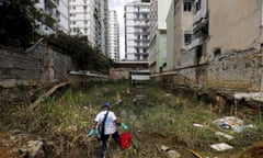 A health worker in Rio de Janeiro uses guppy fish to try to control the breeding of the mosquitoes carrying the Zika virus.